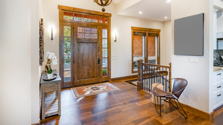 Rustic entryway with wood floors and stairs