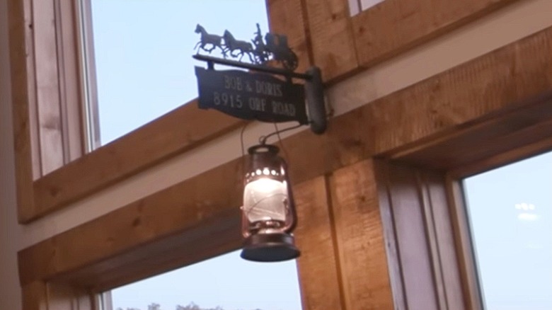 Closeup of a lantern handing from a sign inside a house