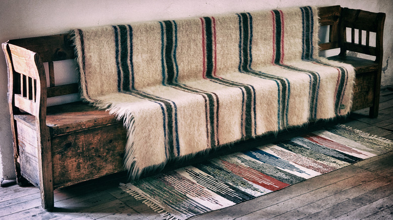 Wool blancket laying over an old wooden bench