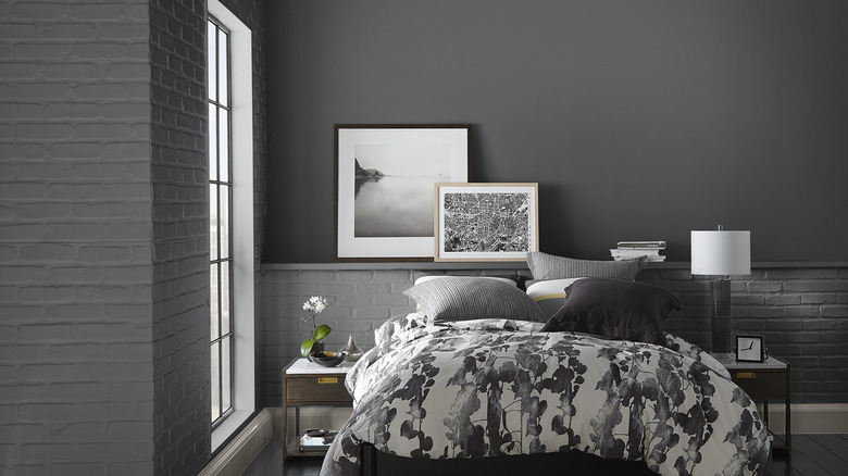 A bedroom wall is painted Behr Cracked Pepper above a white brick ledge