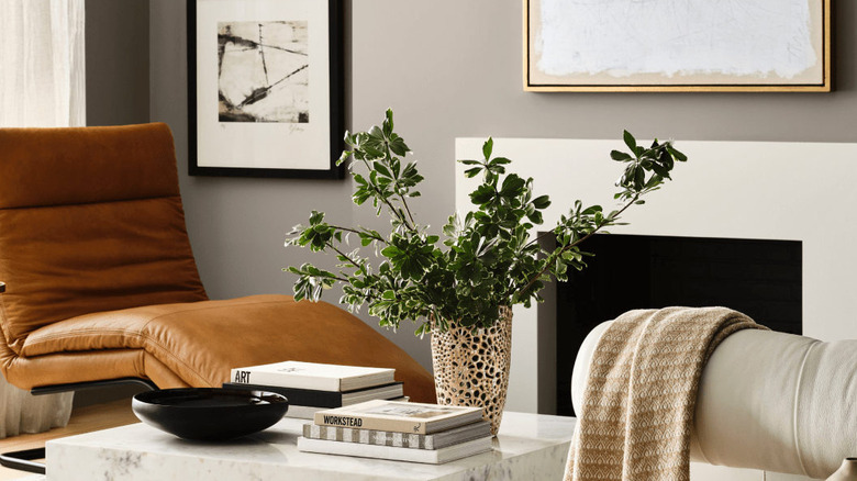 The walls of a neutral living room are painted in Sherwin-Williams Pavestone