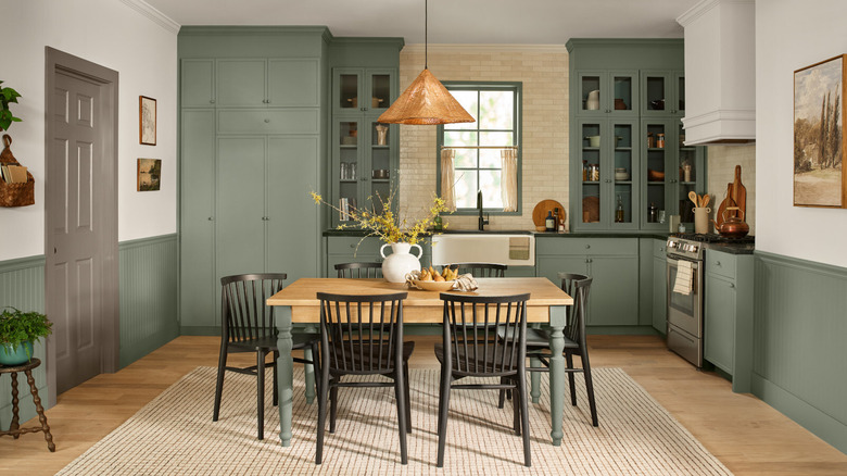 Cabinets in a neutral eat-in kitchen are painted with Valspar's Warm Eucalyptus
