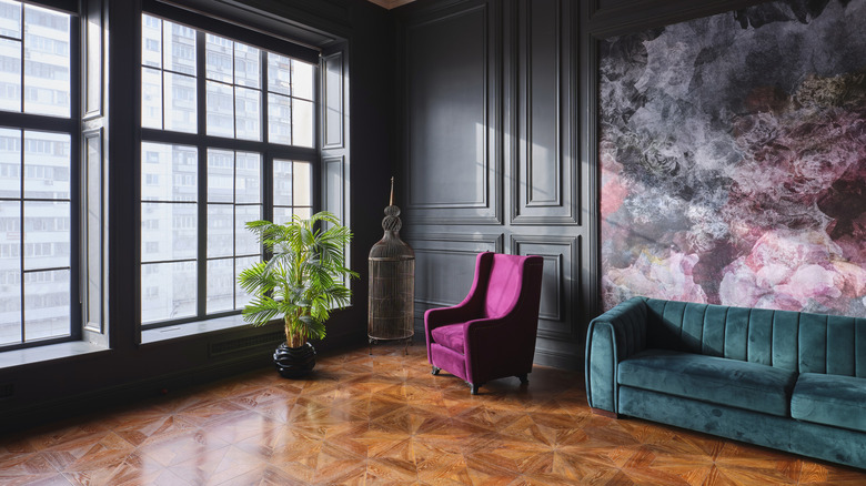 A bold living room features wood parquet flooring