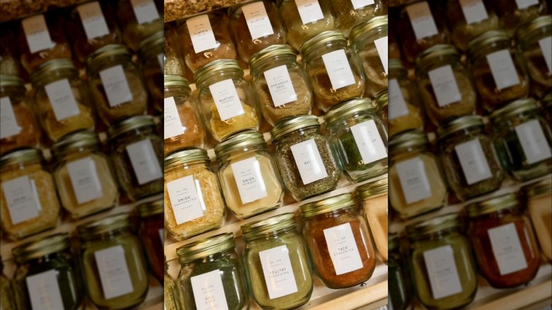 Dollar Tree jars filled with spices in a drawer