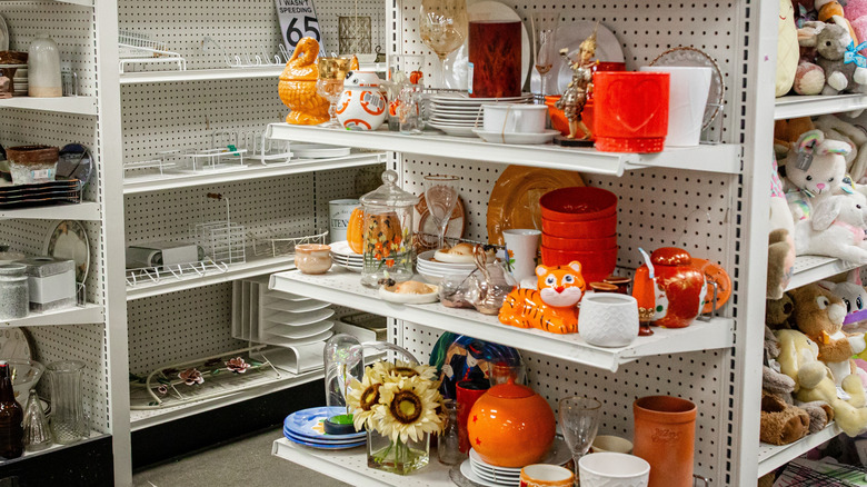 Thrift store shelves with various cookware