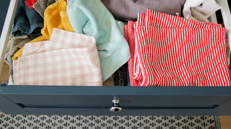 Dish towels cluttering open drawer
