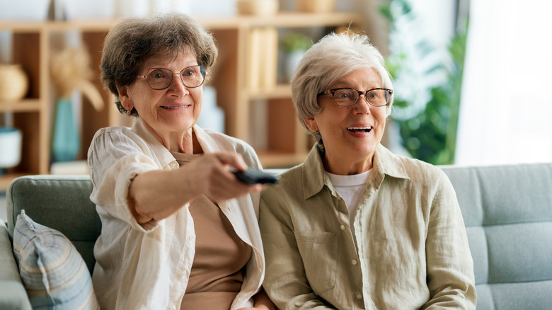 Ladies watching TV together.