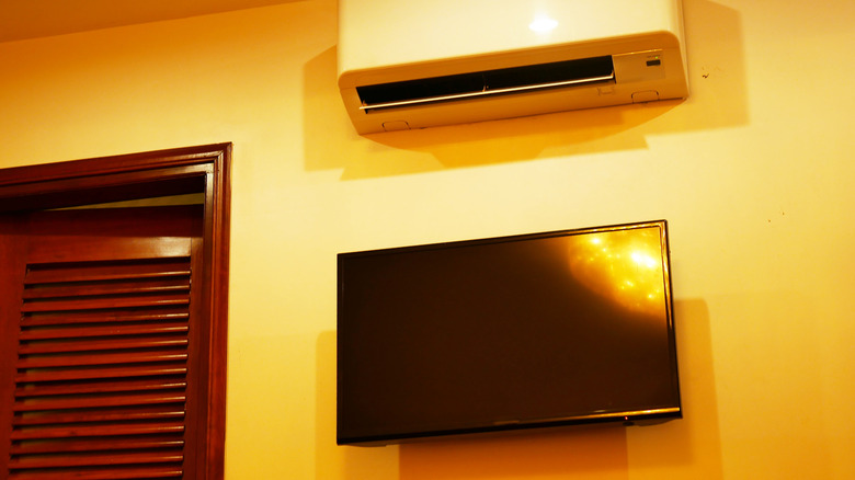 An AC unit on the wall of a living room.