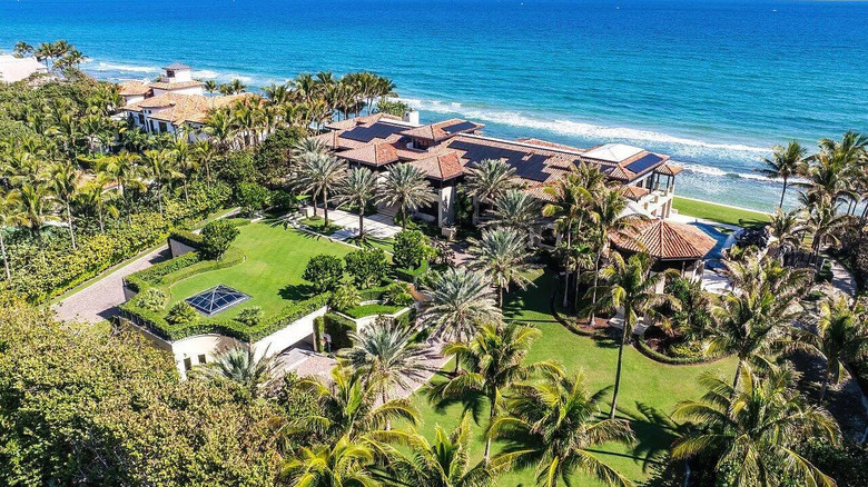 Manaplan Florida mansion on private beach wiith palm trees and