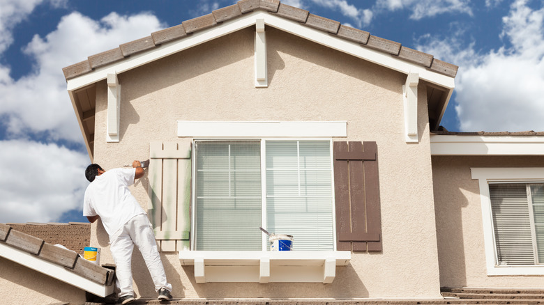 Man painting shutters