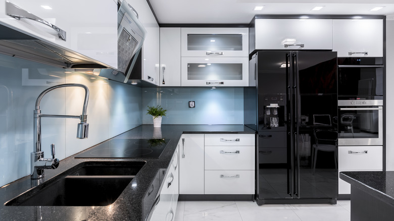 black fridge in white kitchen