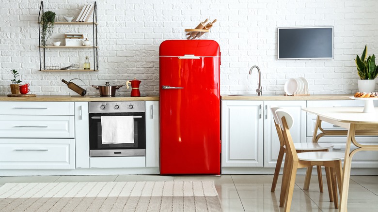 red refrigerator in white kitchen