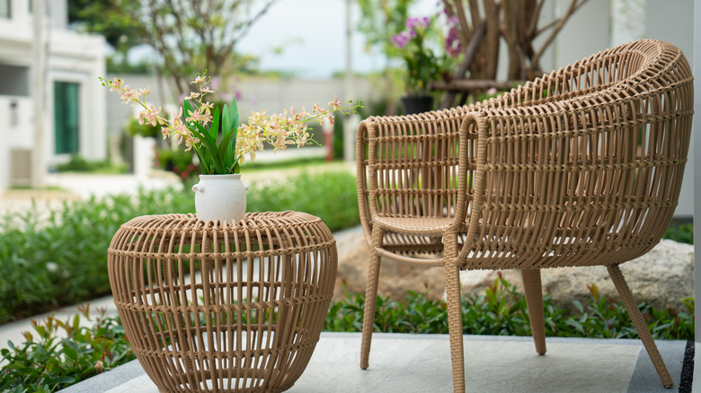 wicker chair and table with plant on top
