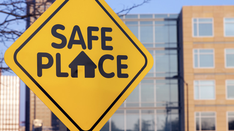 Yellow sign that says Safe Place in front of a building