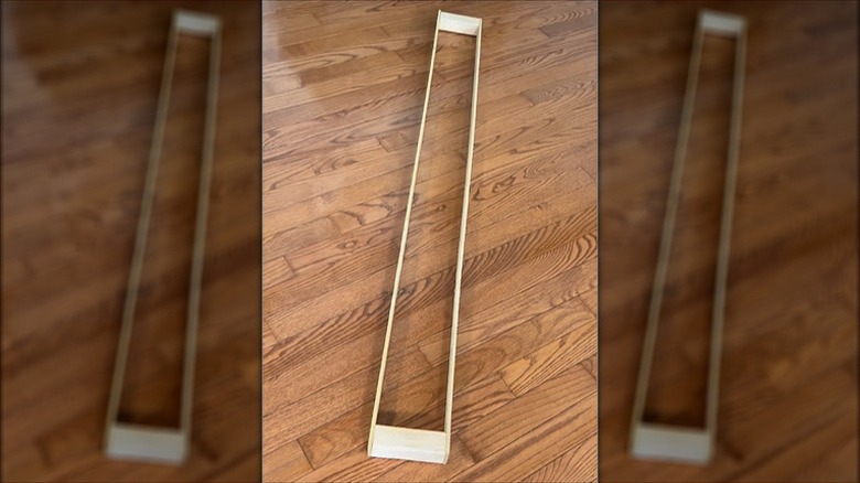 A wood frame is made from two blocks and two long shims.