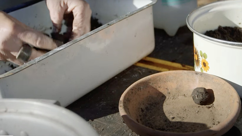 person making seed bombs