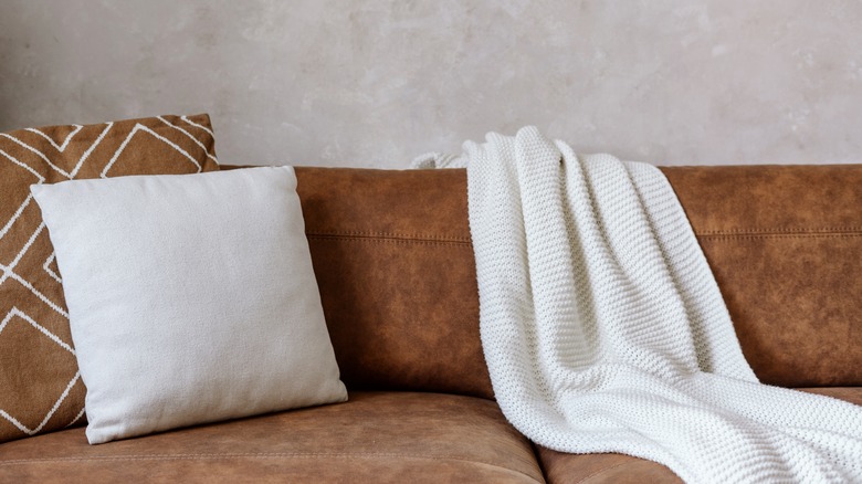 Plain white throw on brown couch