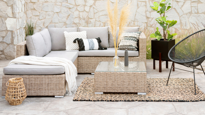 Rattan furniture and organic rug on an outdoor patio