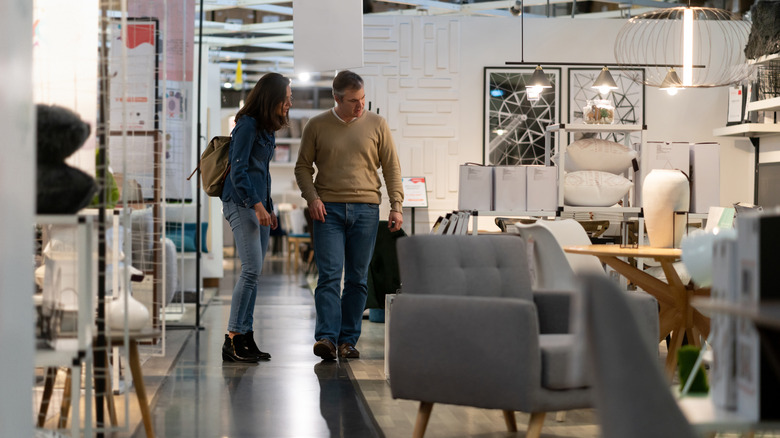couple browsing the aisle at a furniture store