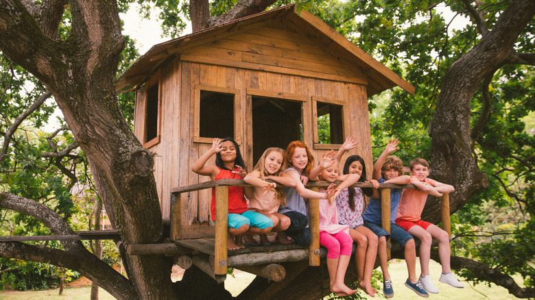 Children sitting on a treehouse