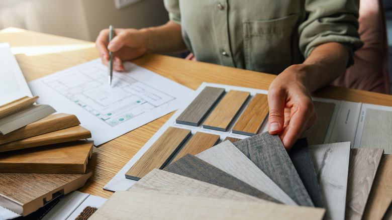 woman at desk looking at sustainable flooring samples