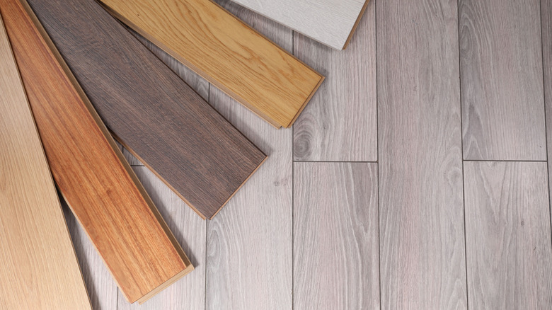 samples of sustainable flooring spread across a grey wood floor