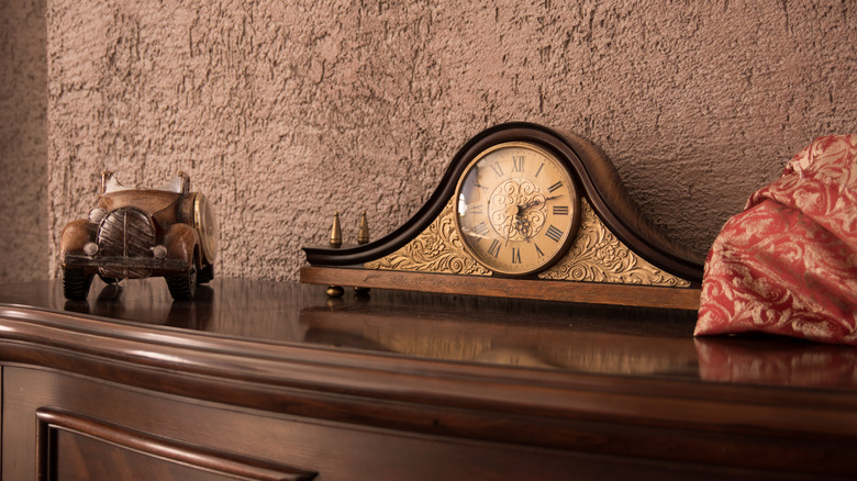 A vintage clock on a console table