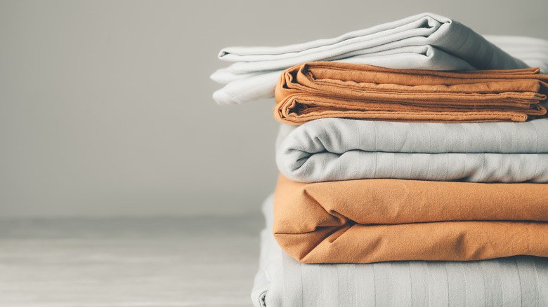 stack of folded bed sheets