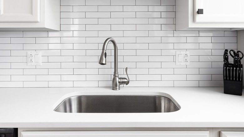 Kitchen sink with white backsplash