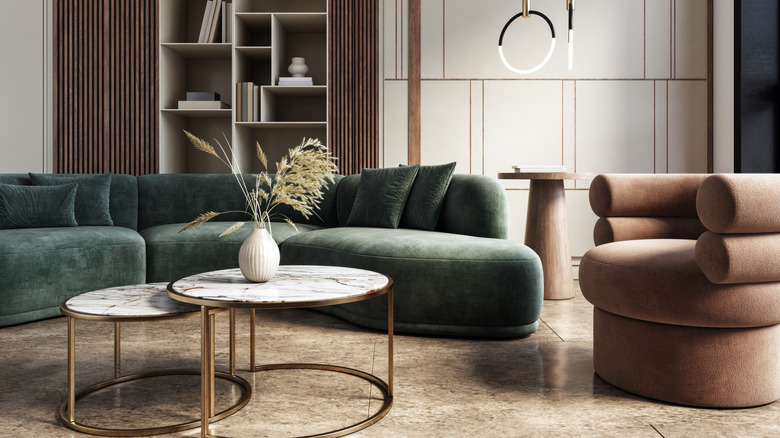 Green and brown living room furniture with nestled coffee tables