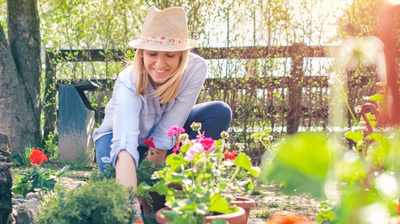 A woman preparing to plant flowers in garden.