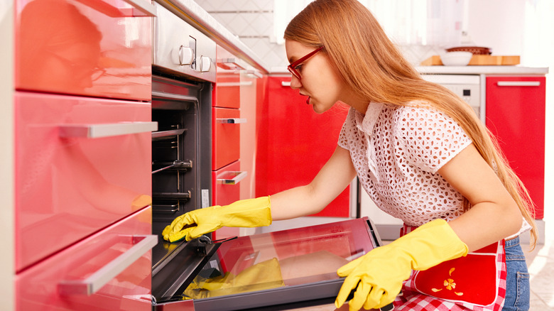 Woman cleaning oven