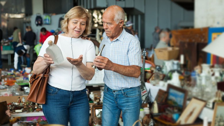 Two older people antique shopping.