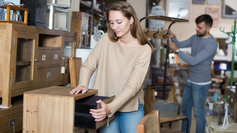 A couple shopping for furniture at a secondhand store