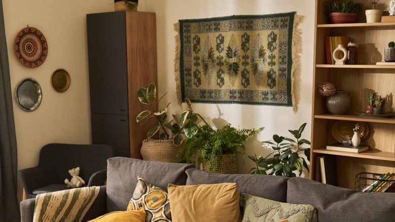 Modern living room with a medium sized wall tapestry hung behind the sofa