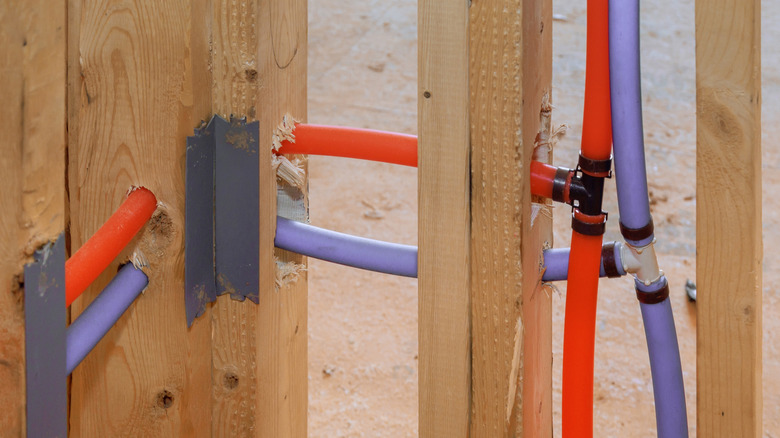 Blue and red water lines running through framing