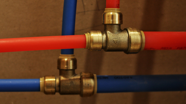 Red and blue PEX pipes with metal connections