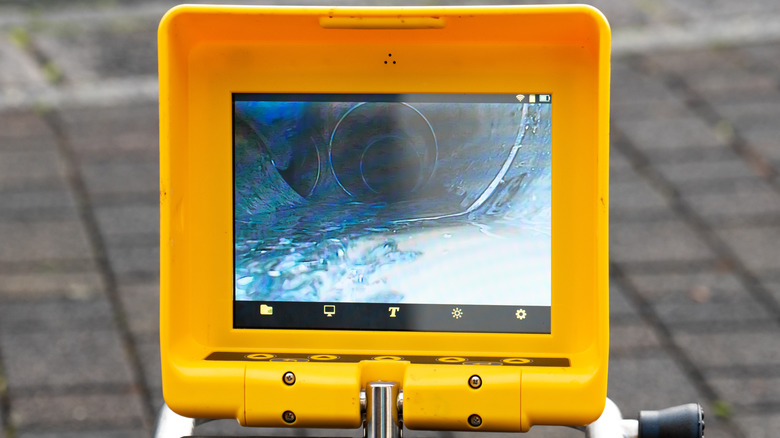 Yellow screen showing the feed from a sewer camera