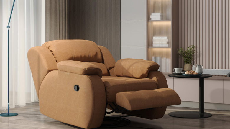 A modern brown recliner in a living room.
