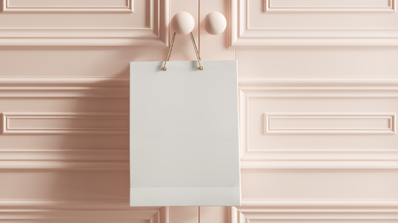 A shopping bag hanging on a door