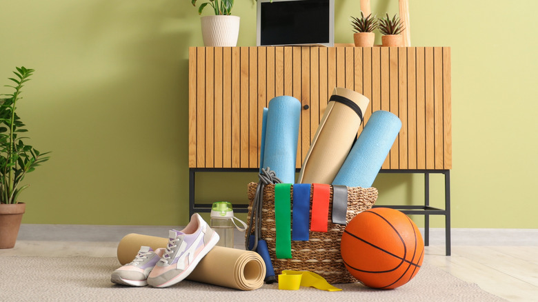 Sports equipment in front of an entryway table