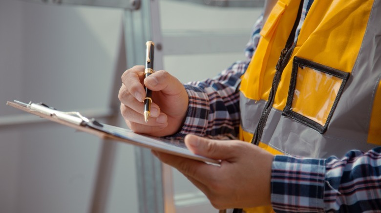 Home inspector making report 