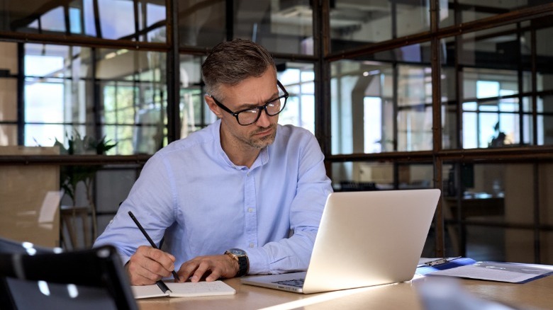Man doing computer researching 