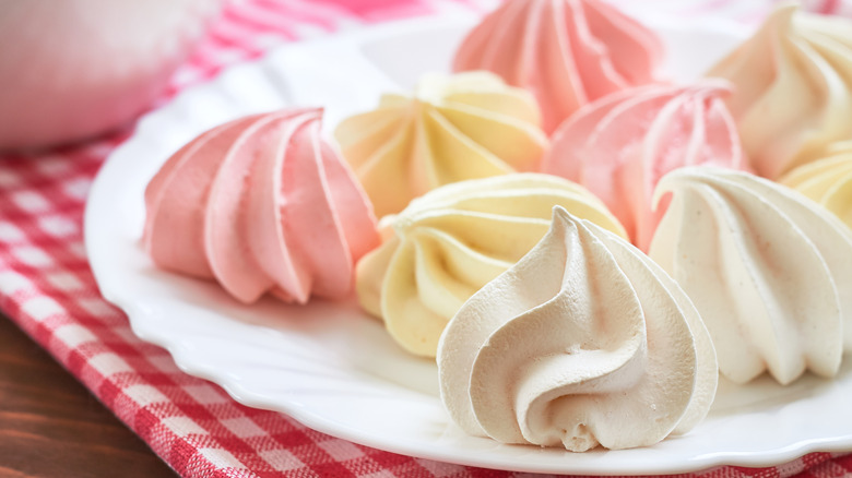 Colored meringue cookies served on a white plate