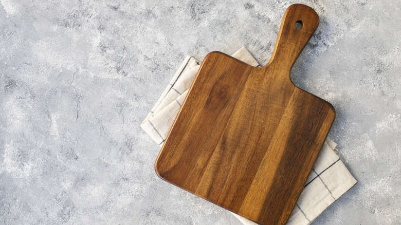 Wood cutting board over a marble table