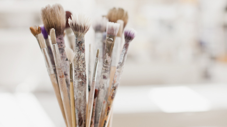 Close up of artist paint brushes standing upright