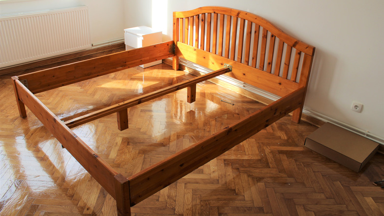 A wood bed frame with no mattress.