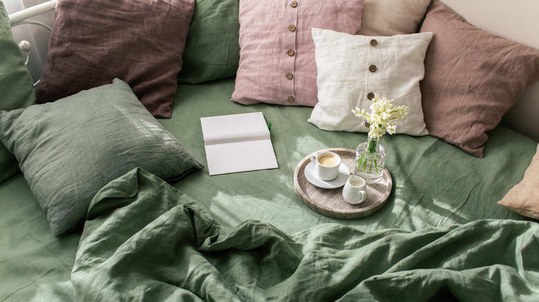 Linen bed sheets and pillows with a tray.