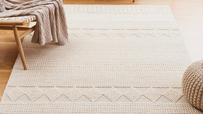 A beige natural woven wool area rug.