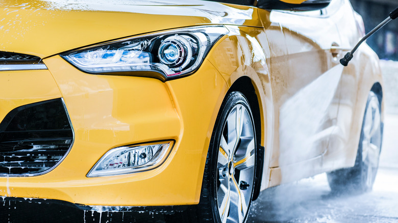 Pressure washing automobile